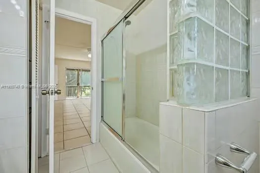 a bathroom with a shower and mirror
