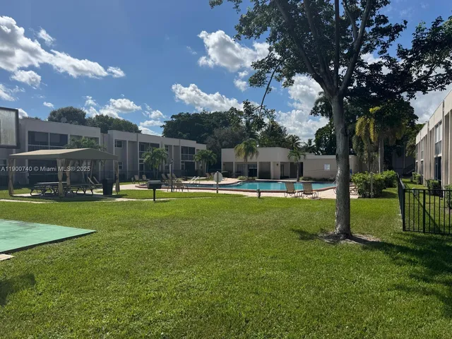 a swimming pool with outdoor seating and yard