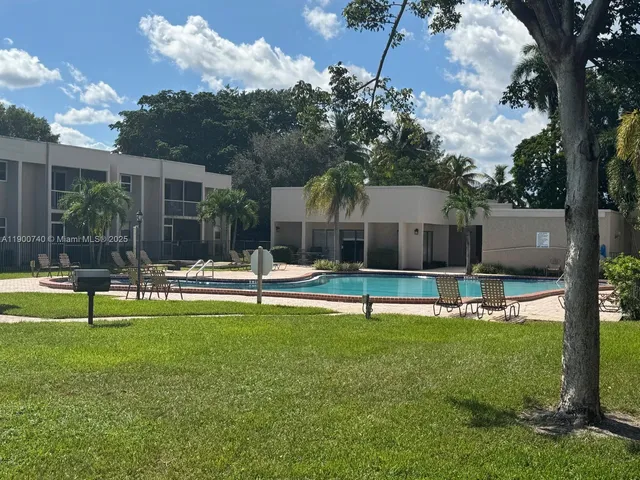 a view of a house with swimming pool and a yard