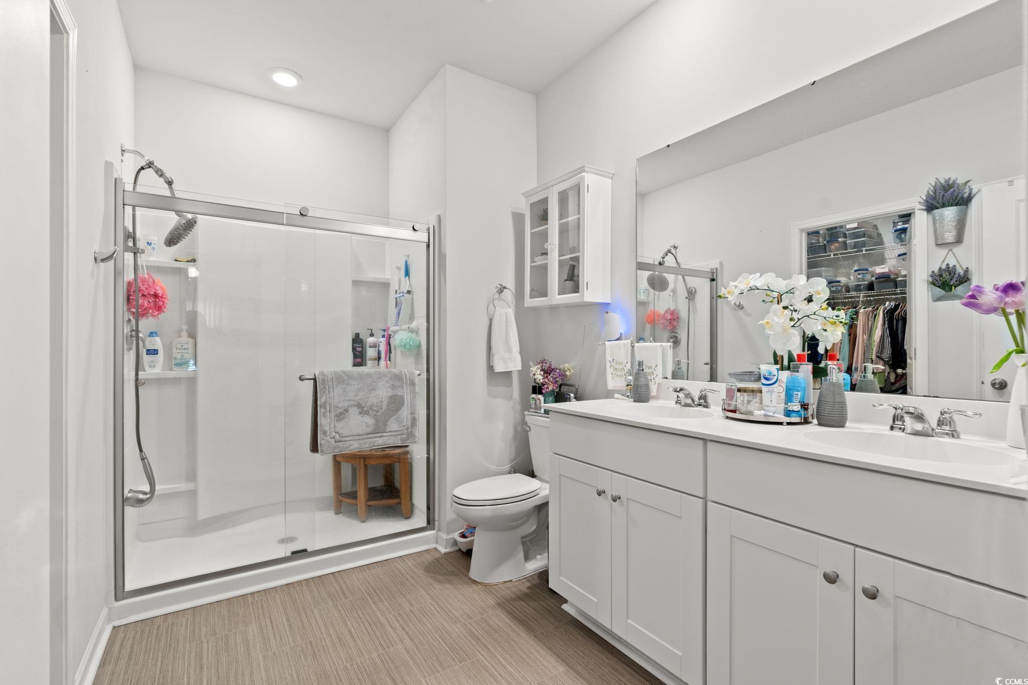 155 Marsh Deer Place Surfside Beach, SC 29575 - Photo 13 of 35 Full bathroom featuring a shower stall, double vanity, a sink, and toilet