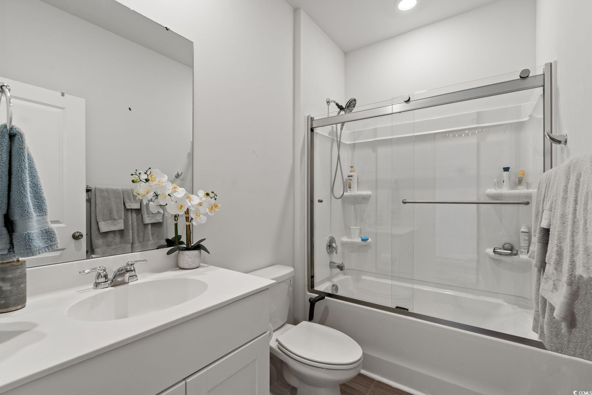 155 Marsh Deer Place Surfside Beach, SC 29575 - Photo 16 of 35 Full bathroom with combined bath / shower with glass door, vanity, and toilet