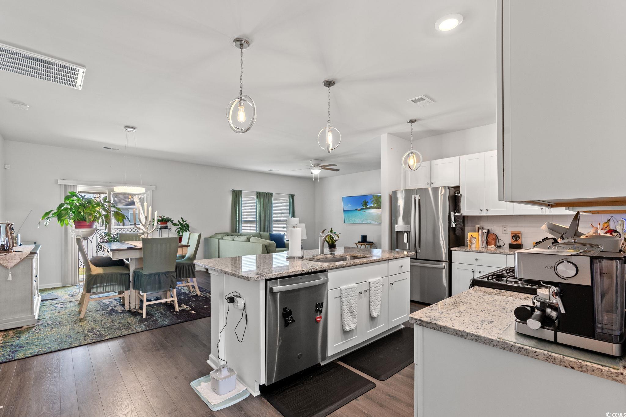 155 Marsh Deer Place Surfside Beach, SC 29575 - Photo 4 of 35 Kitchen featuring white cabinetry, visible vents, a kitchen island, appliances with stainless steel finishes, and a sink