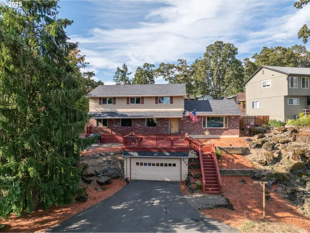 a view of a chairs and table in the backyard