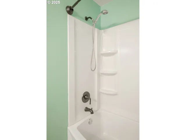 a bathroom with a shower and a sink