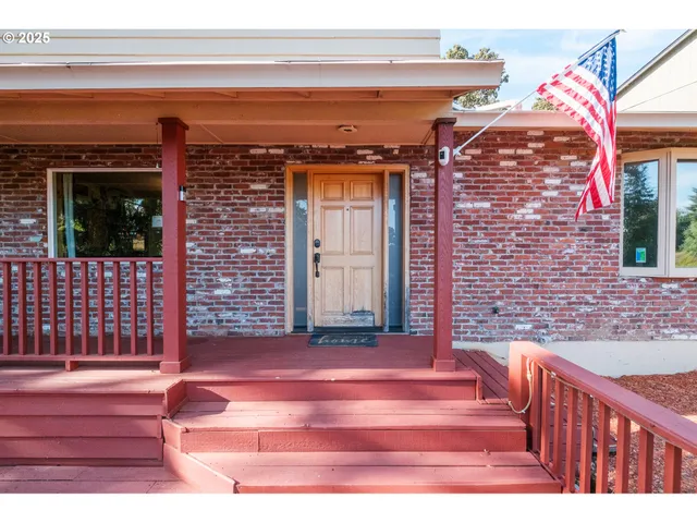 a view of a brick house with wooden floor and a fireplace