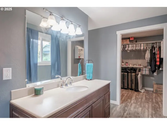 a bathroom with a sink a large mirror and a bathtub