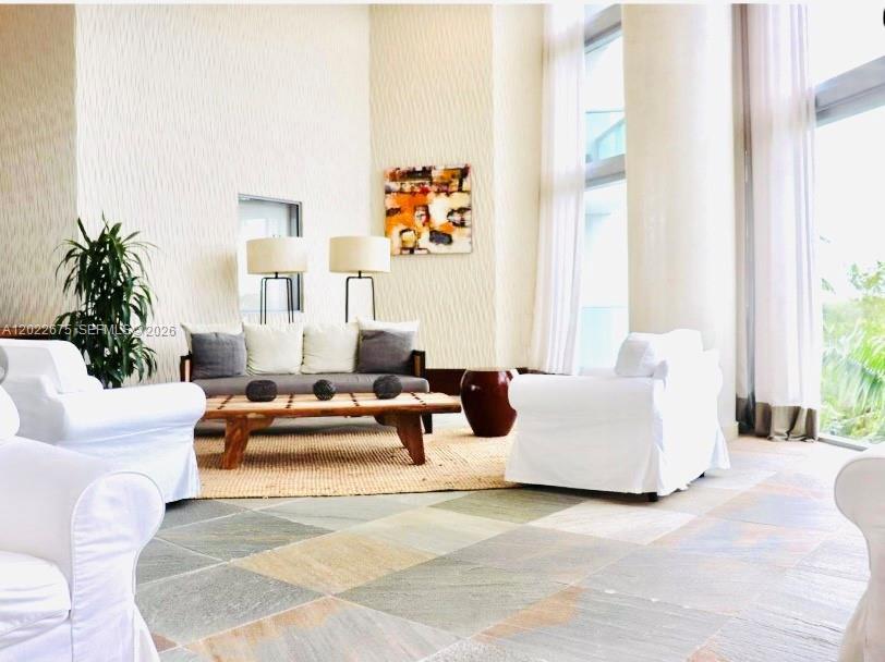2681 North Flamingo Road, Unit 2602S Sunrise, FL 33323 - Photo 12 of 18 a living room with furniture and a large window
