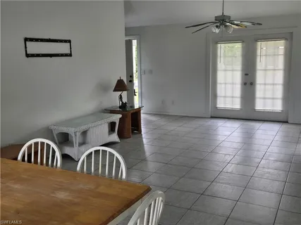 a view of a bedroom with two beds and a window