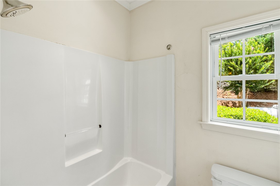 135 Sunset Bay Boulevard Seneca, SC 29672 - Photo 33 of 50 Bright, white tub-shower combination with natural light filtering through the window.