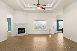 an empty room with windows and fireplace