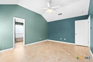 an empty room with closet and fan