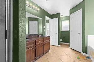a spacious bathroom with a mirror and a shower