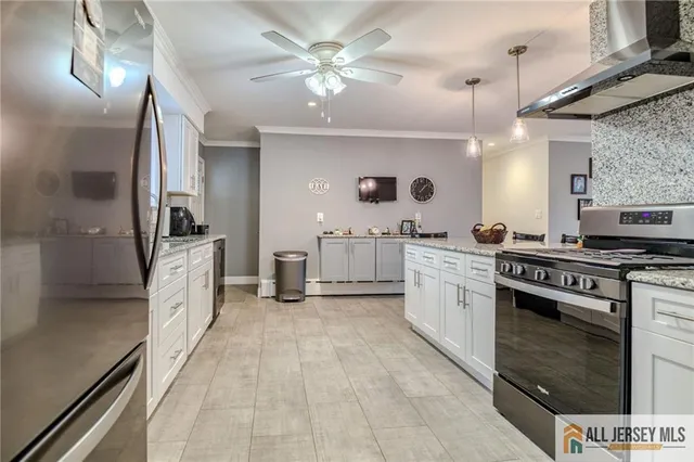 a large kitchen with a stove and cabinets