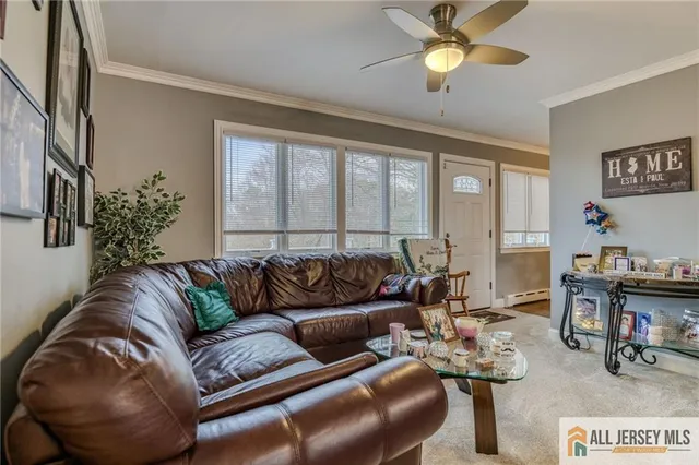 a living room with furniture and a chandelier