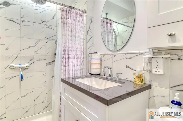 a bathroom with a sink vanity and a mirror