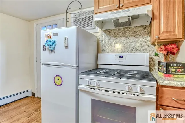 a stove top oven sitting inside of a kitchen
