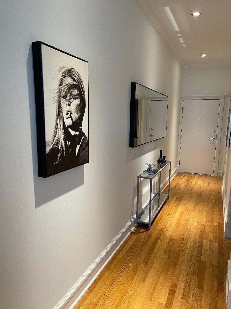 800 West Cornelia Avenue, Unit 307 Chicago, IL 60657 - Photo 8 of 22 a view of a hallway with wooden floor