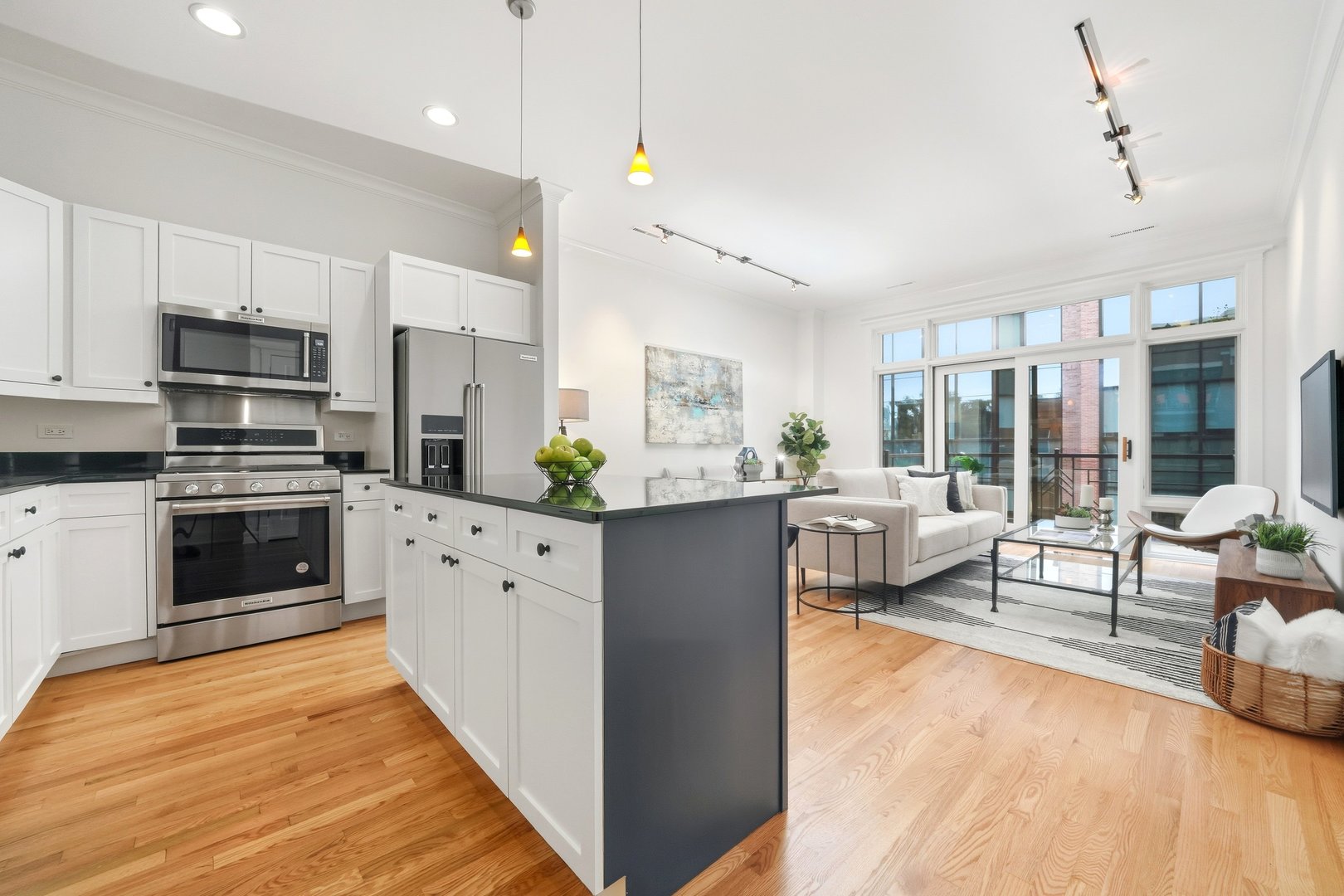 800 West Cornelia Avenue, Unit 307 Chicago, IL 60657 - Photo 10 of 22 a kitchen with stainless steel appliances kitchen island granite countertop a refrigerator a stove oven a sink dishwasher and white cabinets with wooden floor