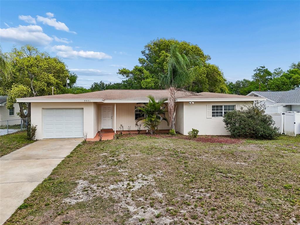 9931 110th Street Seminole, FL 33772 - Photo 1 of 52 front view of a house and a yard