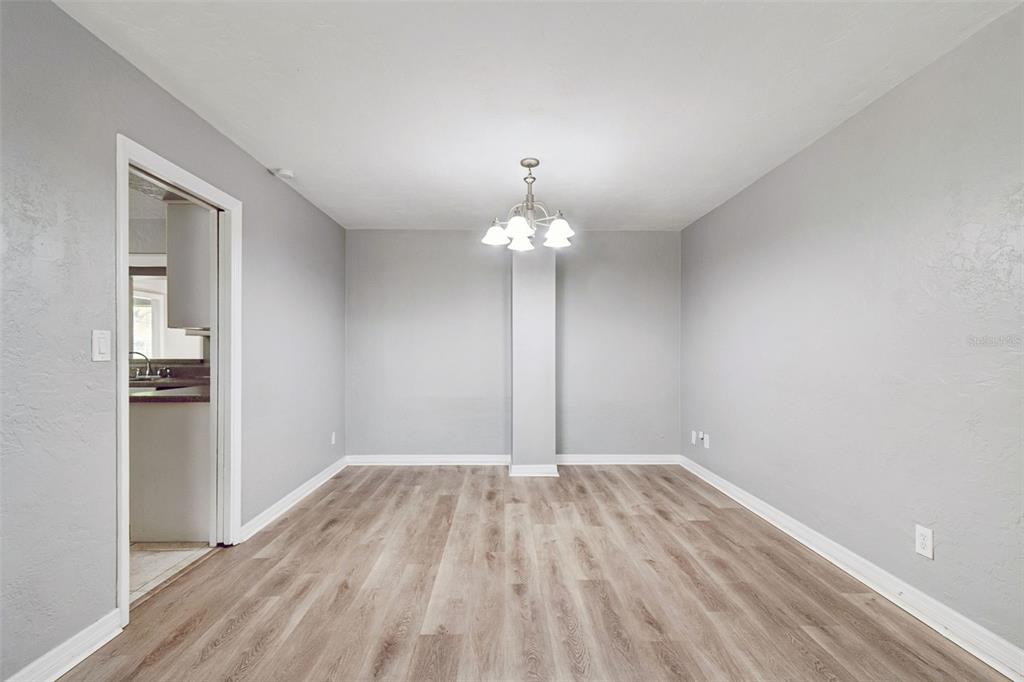 9931 110th Street Seminole, FL 33772 - Photo 13 of 52 wooden floor in an empty room with a window
