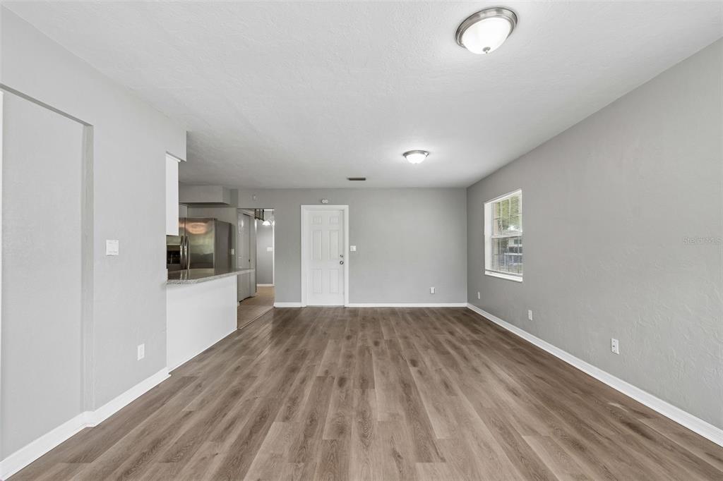 9931 110th Street Seminole, FL 33772 - Photo 20 of 52 a view of an empty room with window and wooden floor