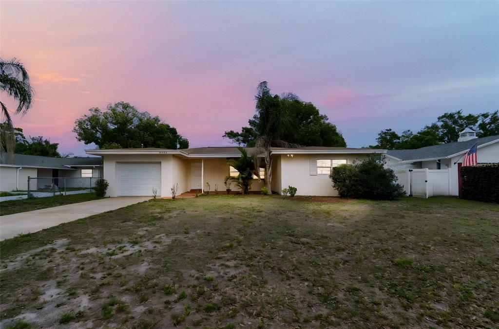 9931 110th Street Seminole, FL 33772 - Photo 2 of 52 a front view of a house with a yard and garage