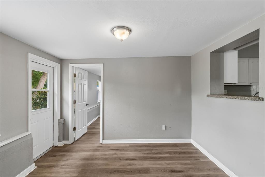 9931 110th Street Seminole, FL 33772 - Photo 21 of 52 wooden floor in an empty room with a window