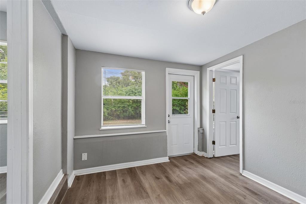 9931 110th Street Seminole, FL 33772 - Photo 22 of 52 an empty room with wooden floor and windows