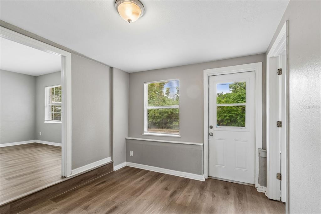 9931 110th Street Seminole, FL 33772 - Photo 23 of 52 an empty room with wooden floor and windows