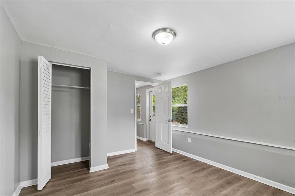 9931 110th Street Seminole, FL 33772 - Photo 27 of 52 a view of an empty room with window and wooden floor