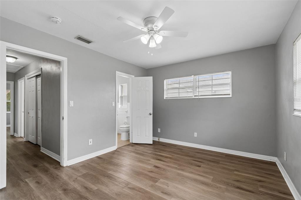 9931 110th Street Seminole, FL 33772 - Photo 29 of 52 a view of an empty room with wooden floor and a ceiling fan