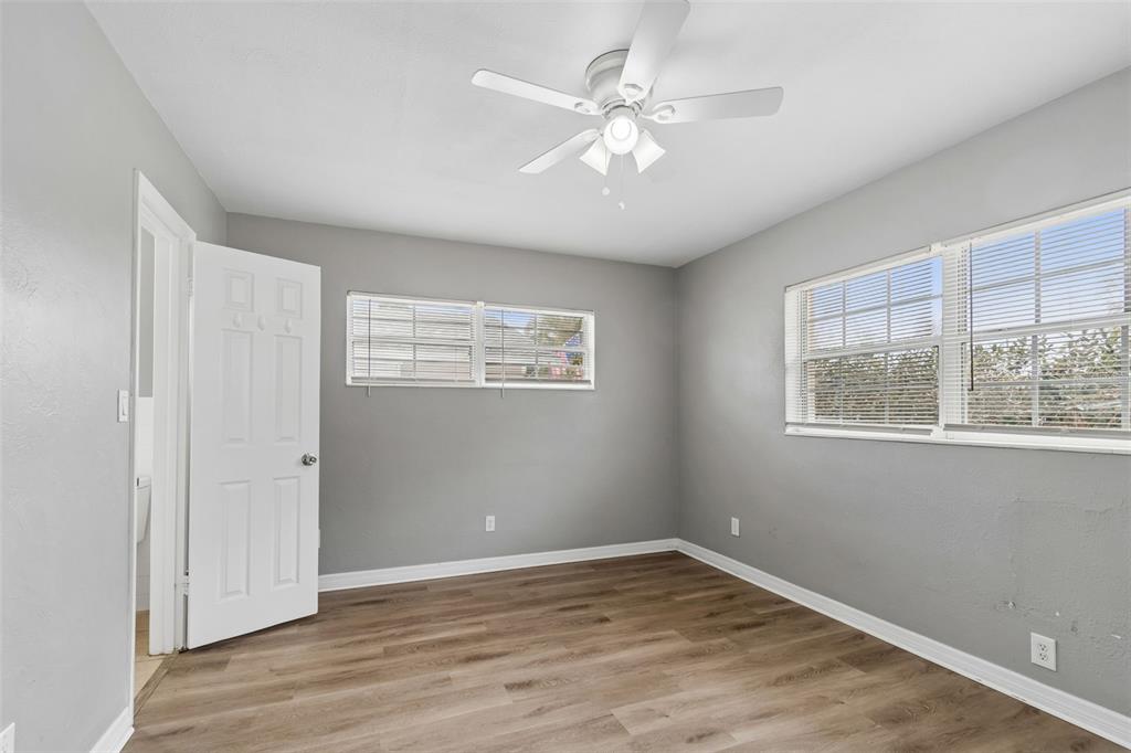 9931 110th Street Seminole, FL 33772 - Photo 30 of 52 a view of an empty room with wooden floor and a window