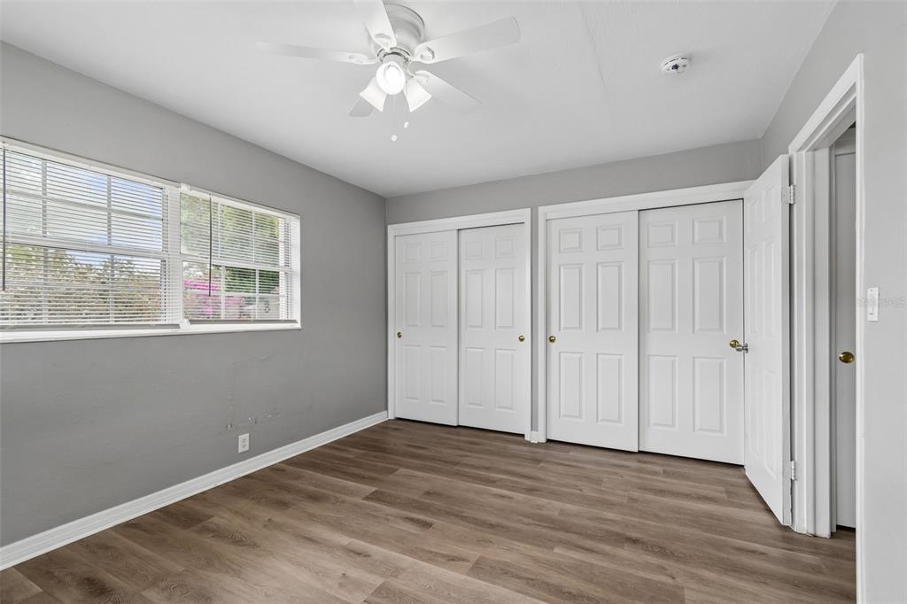 9931 110th Street Seminole, FL 33772 - Photo 32 of 52 a view of an empty room with a window and wooden floor