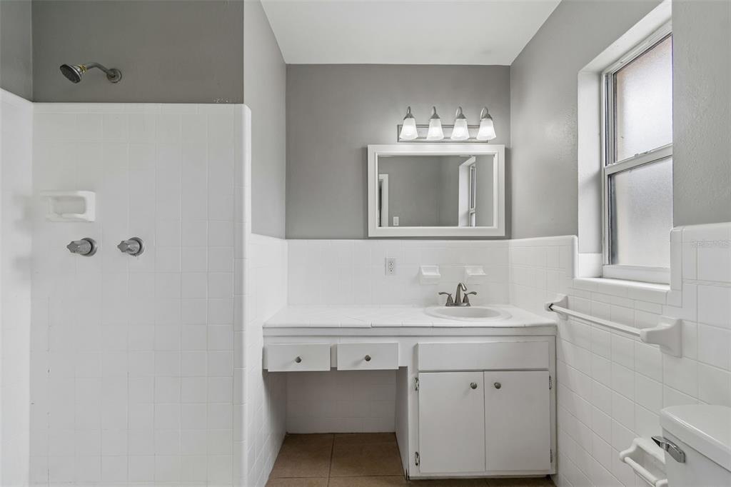 9931 110th Street Seminole, FL 33772 - Photo 33 of 52 a bathroom with a sink and a mirror