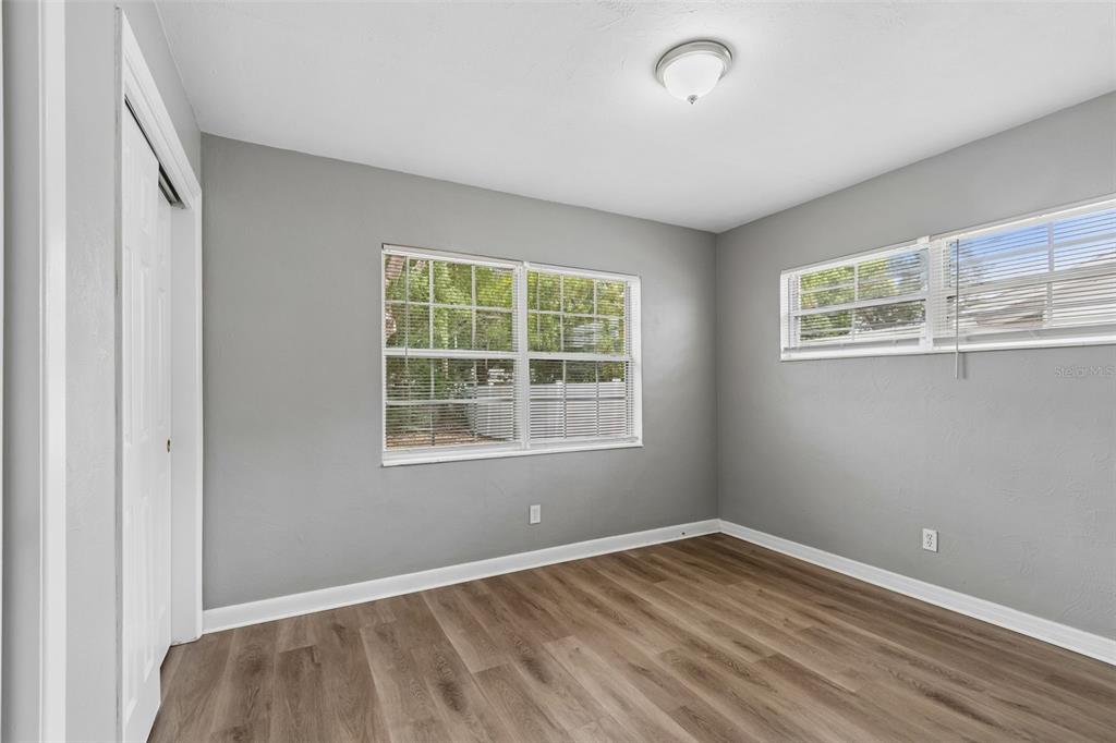 9931 110th Street Seminole, FL 33772 - Photo 36 of 52 a view of empty room with wooden floor and fan