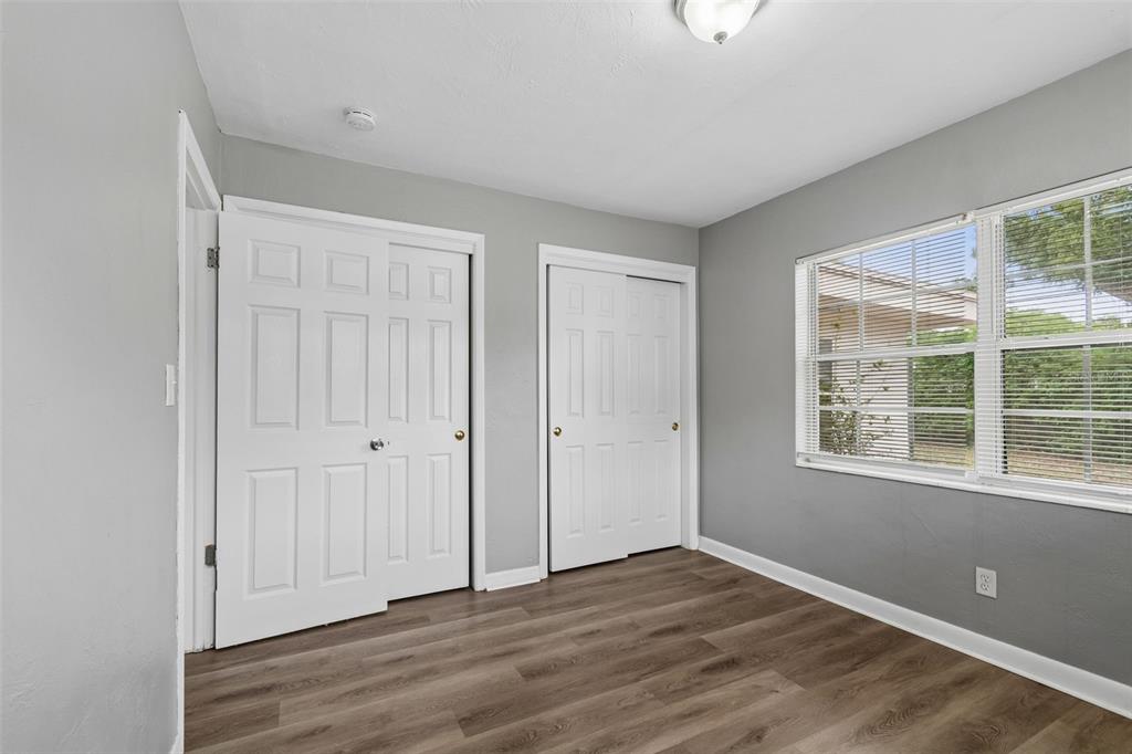 9931 110th Street Seminole, FL 33772 - Photo 38 of 52 a view of an empty room with wooden floor and a window