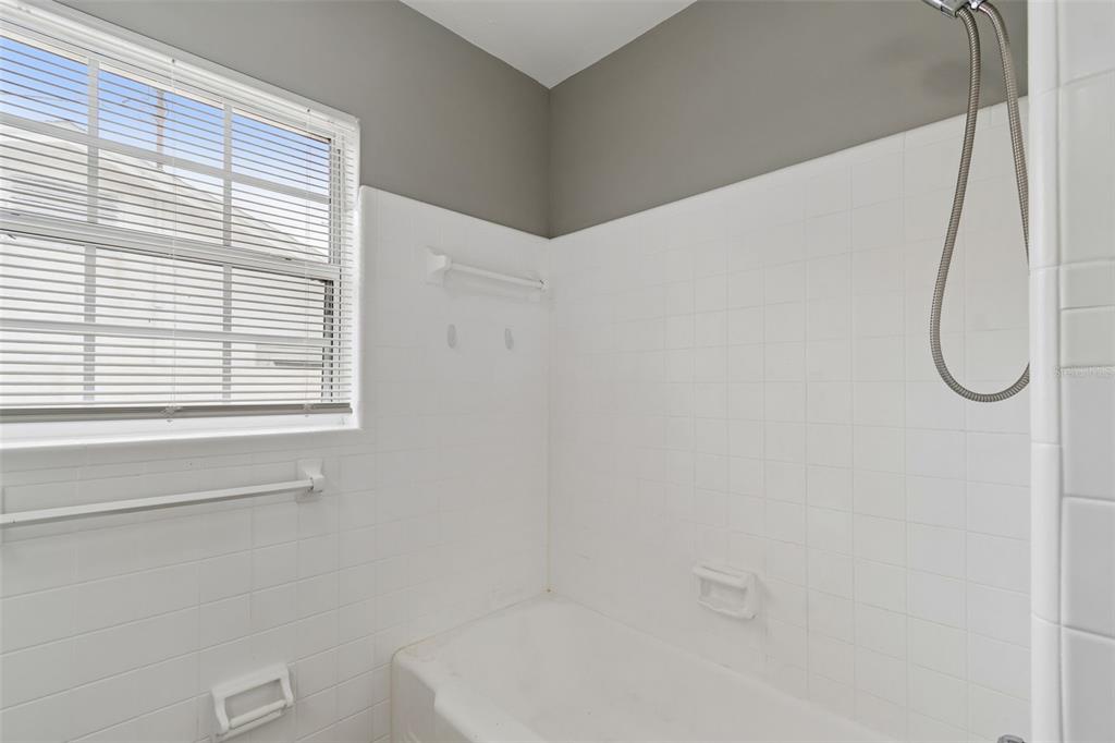 9931 110th Street Seminole, FL 33772 - Photo 39 of 52 a bathroom with a bath tub and a window