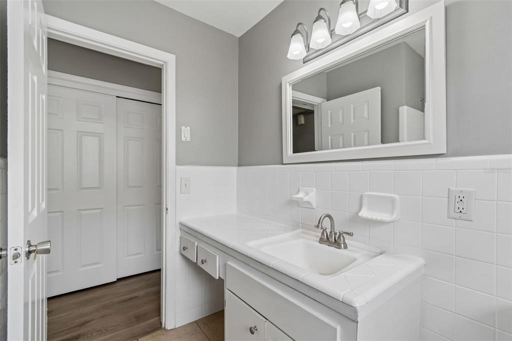 9931 110th Street Seminole, FL 33772 - Photo 40 of 52 a bathroom with a sink vanity and a mirror