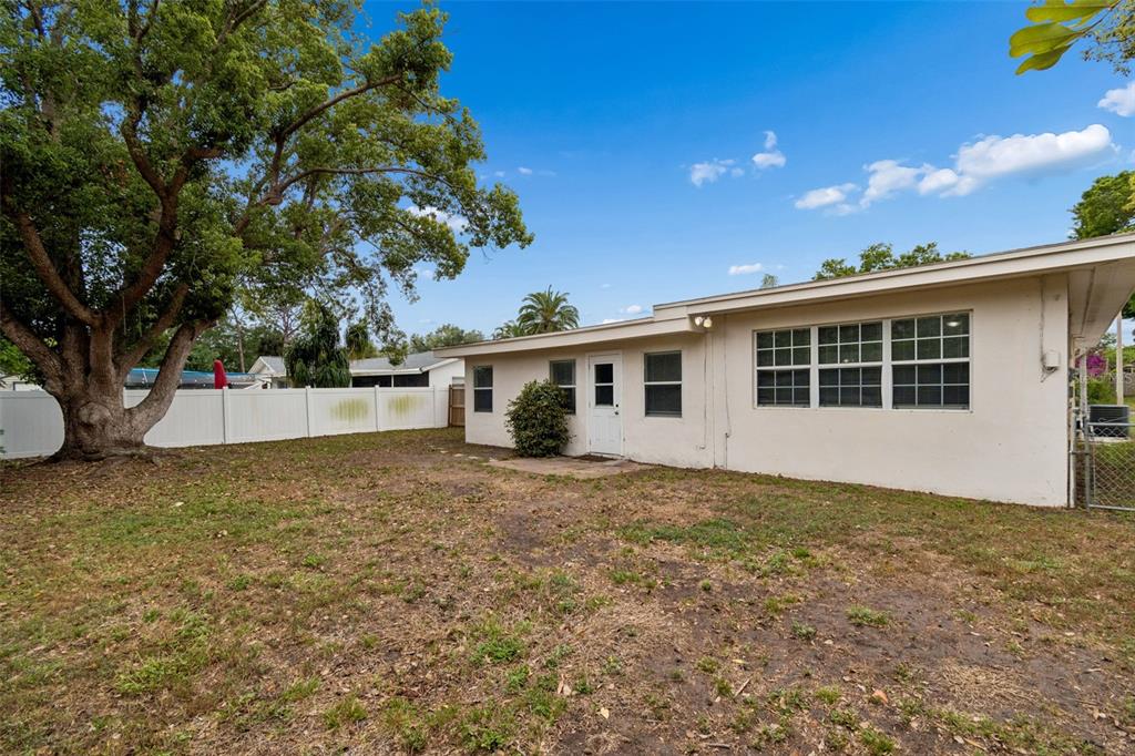 9931 110th Street Seminole, FL 33772 - Photo 43 of 52 a view of a house with a backyard