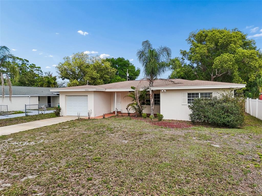 9931 110th Street Seminole, FL 33772 - Photo 5 of 52 a view of a house with a yard and a large tree