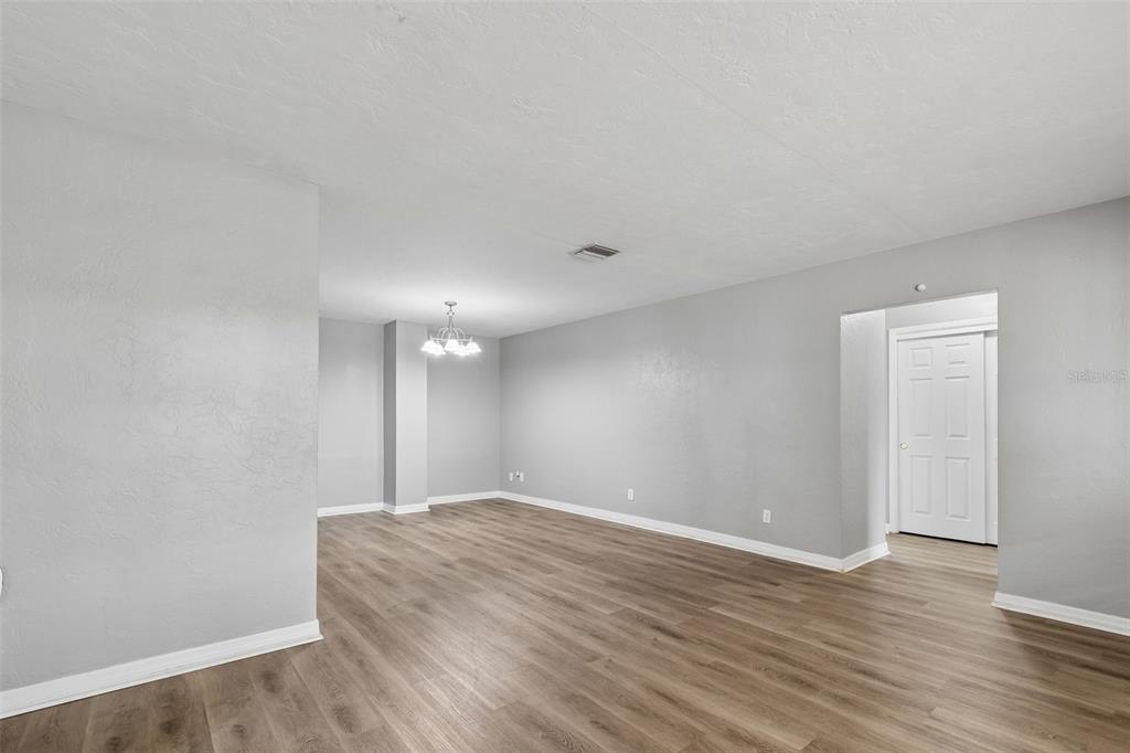 9931 110th Street Seminole, FL 33772 - Photo 9 of 52 a view of an empty room with wooden floor