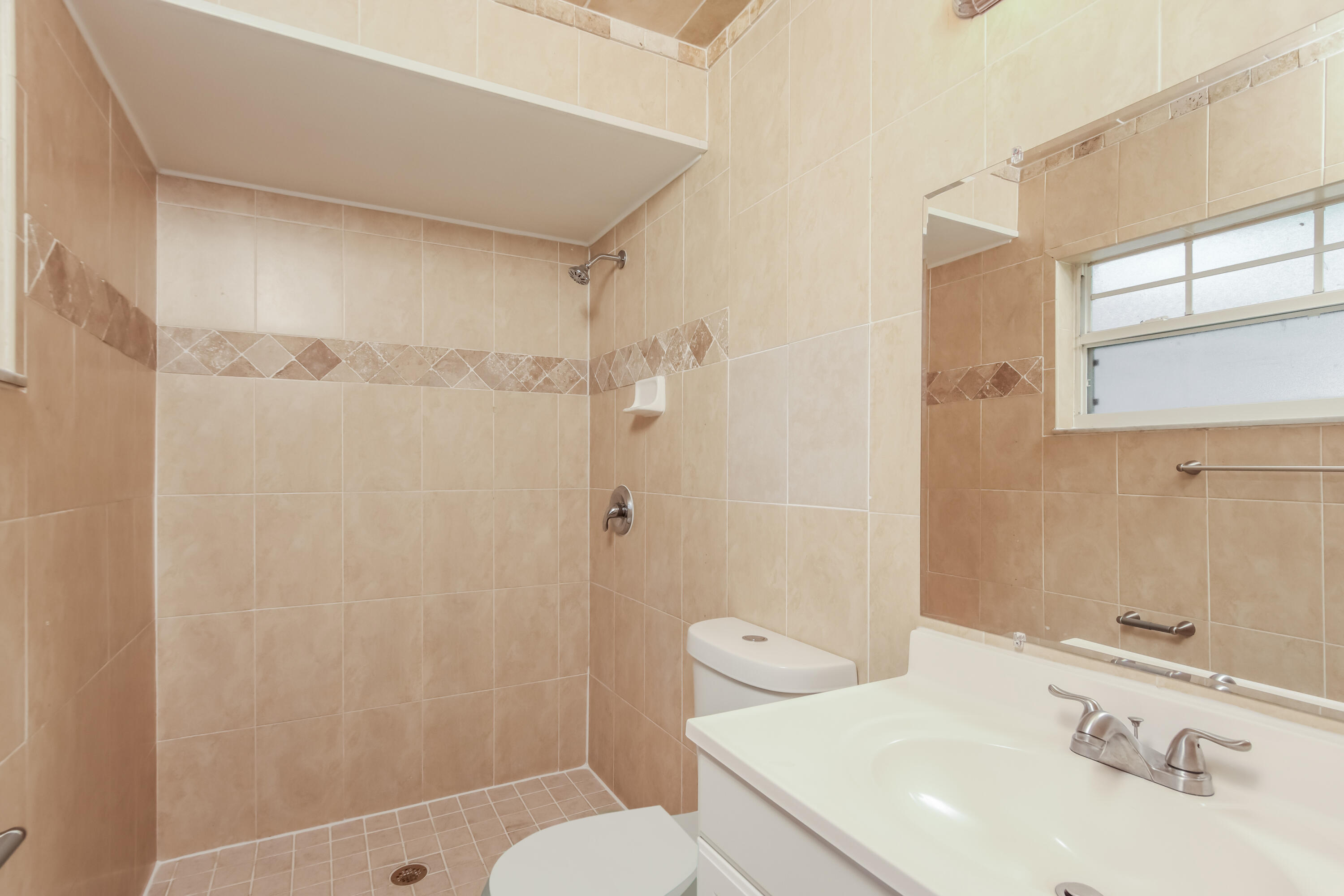 1195 Cotton Road Northeast Palm Bay, FL 32905 - Photo 11 of 17 a bathroom with a sink toilet and shower