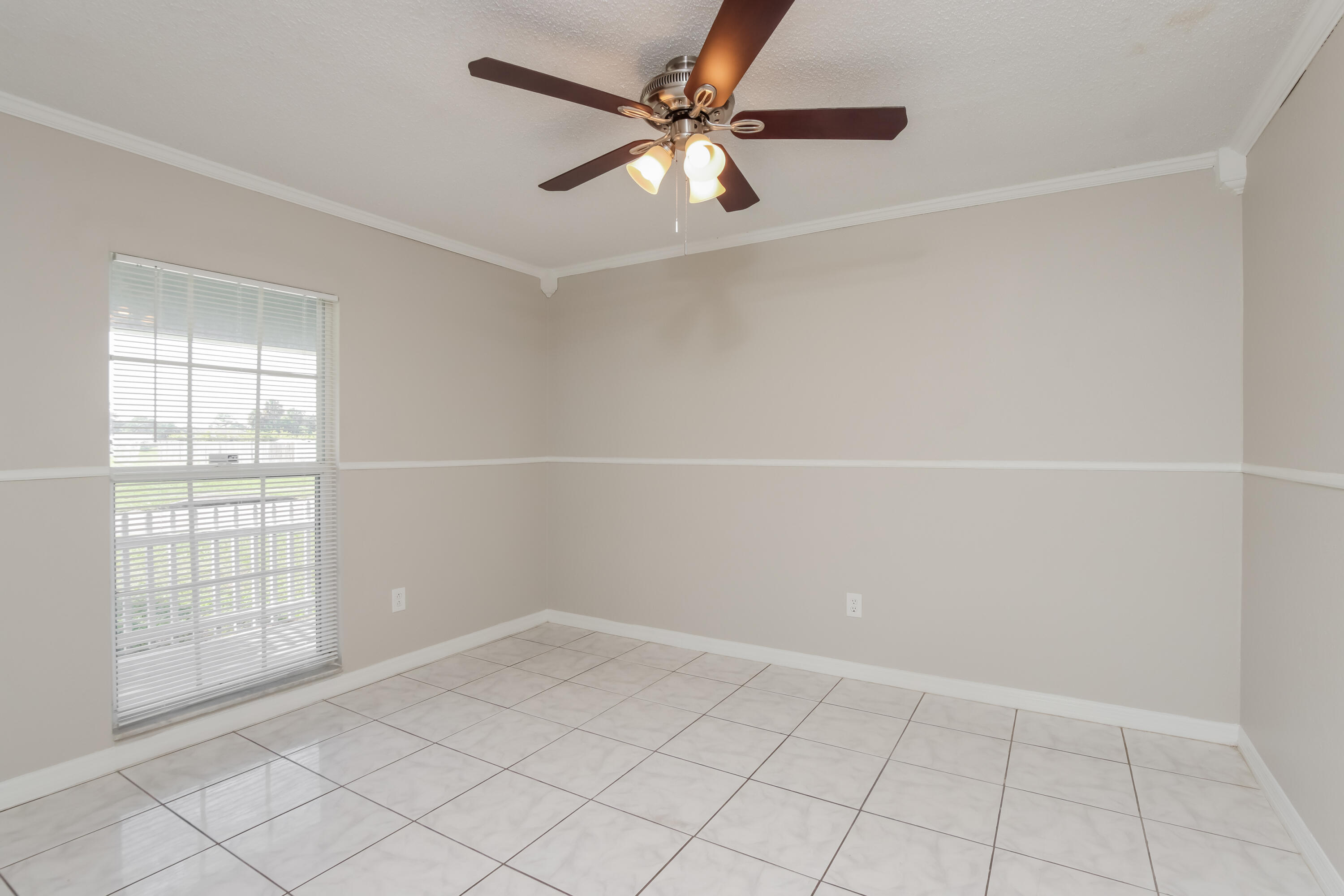 1195 Cotton Road Northeast Palm Bay, FL 32905 - Photo 13 of 17 an empty room with windows and fan