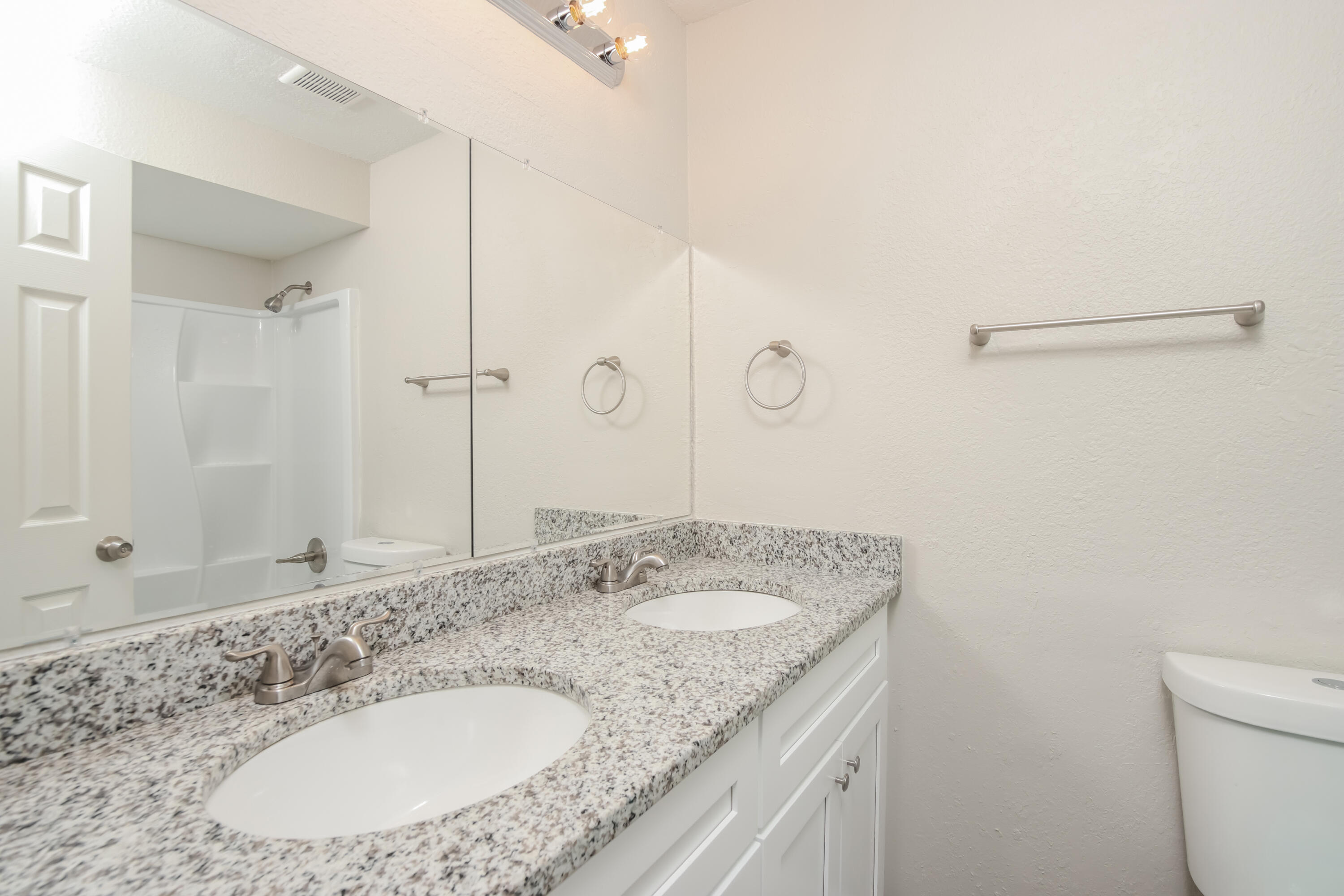 1195 Cotton Road Northeast Palm Bay, FL 32905 - Photo 14 of 17 a bathroom with a granite countertop sink and a mirror