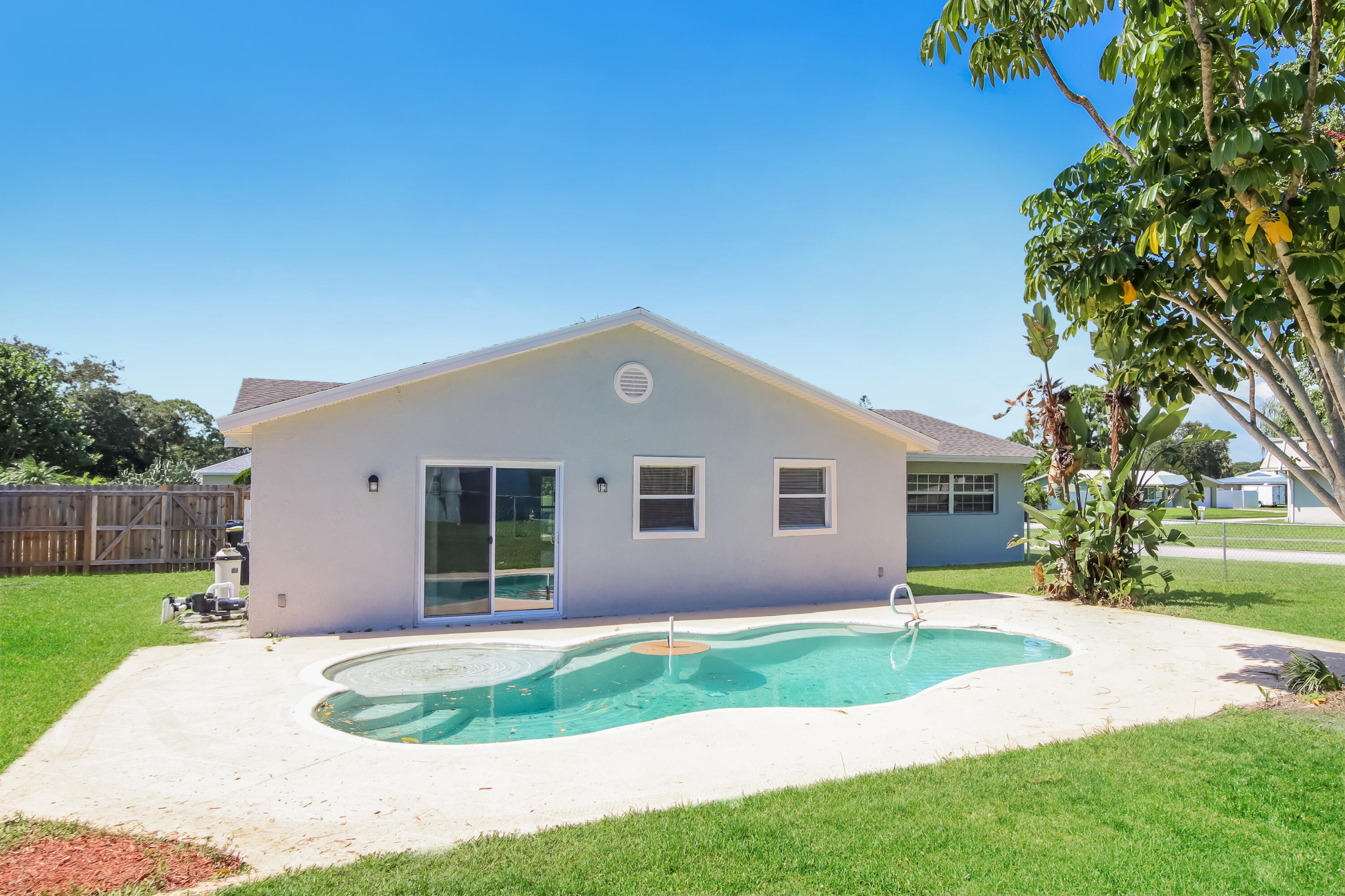 1195 Cotton Road Northeast Palm Bay, FL 32905 - Photo 15 of 17 a front view of house with yard and green space