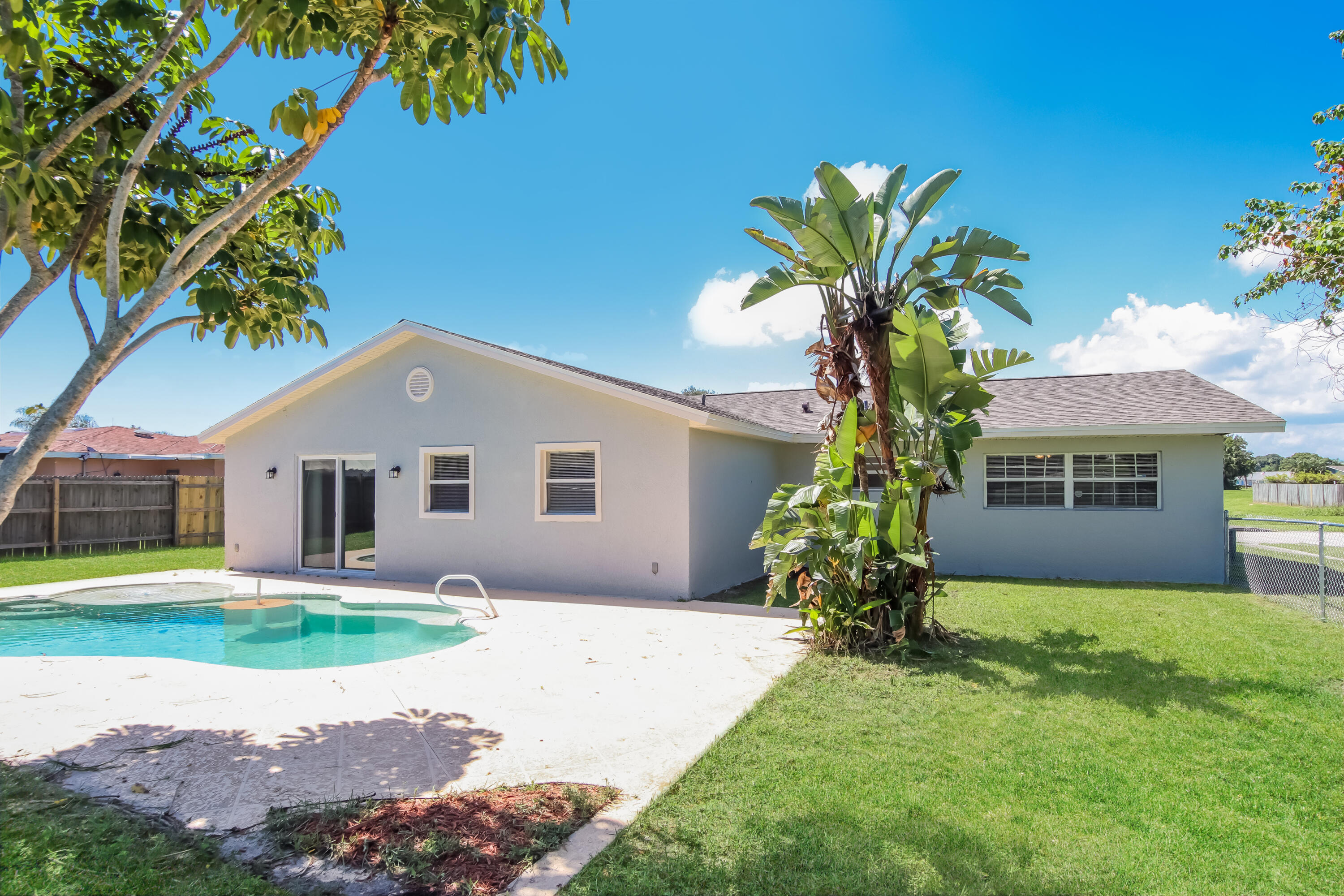 1195 Cotton Road Northeast Palm Bay, FL 32905 - Photo 16 of 17 a front view of a house with a yard and garage