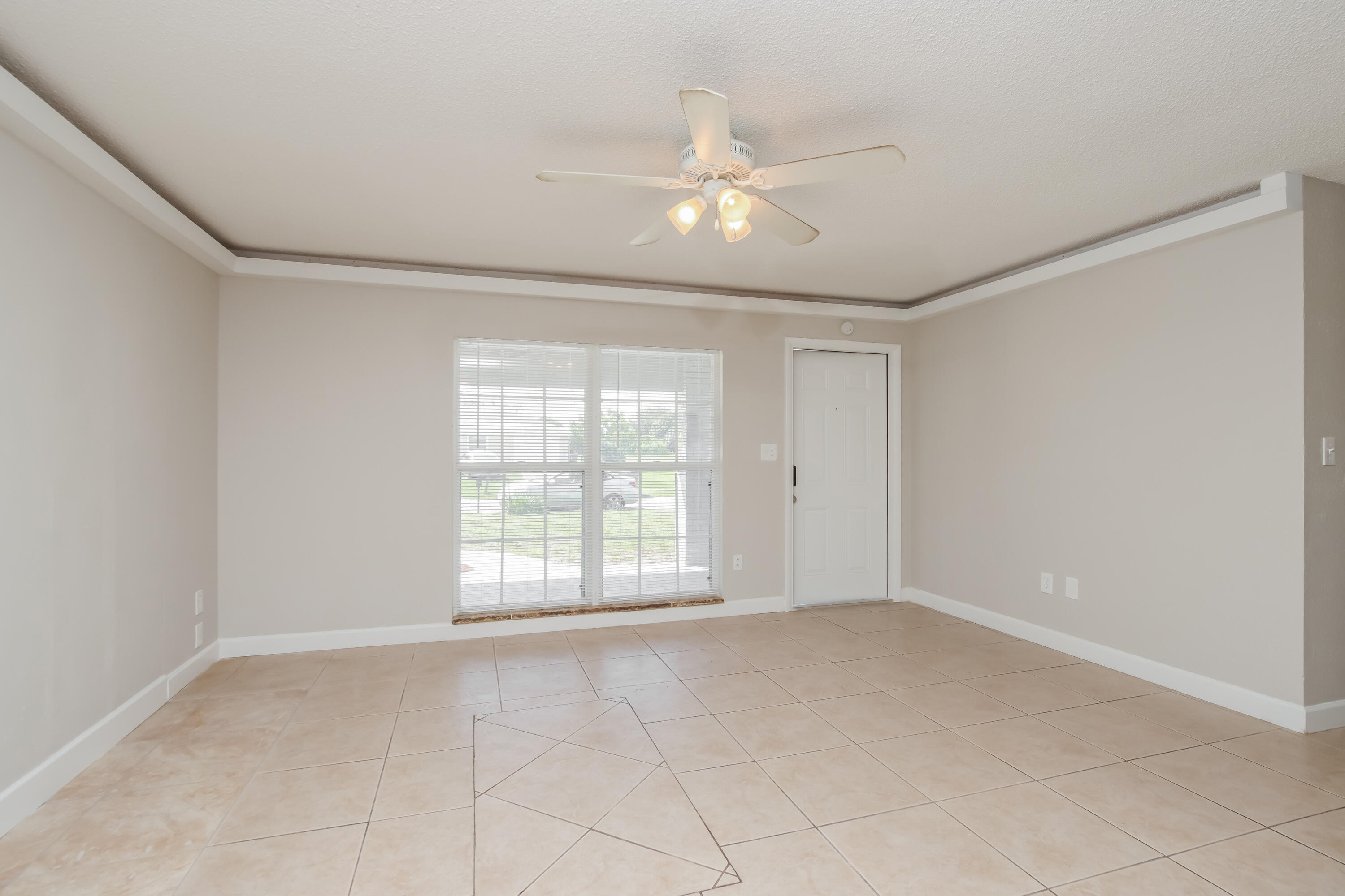 1195 Cotton Road Northeast Palm Bay, FL 32905 - Photo 4 of 17 a view of an empty room with a window