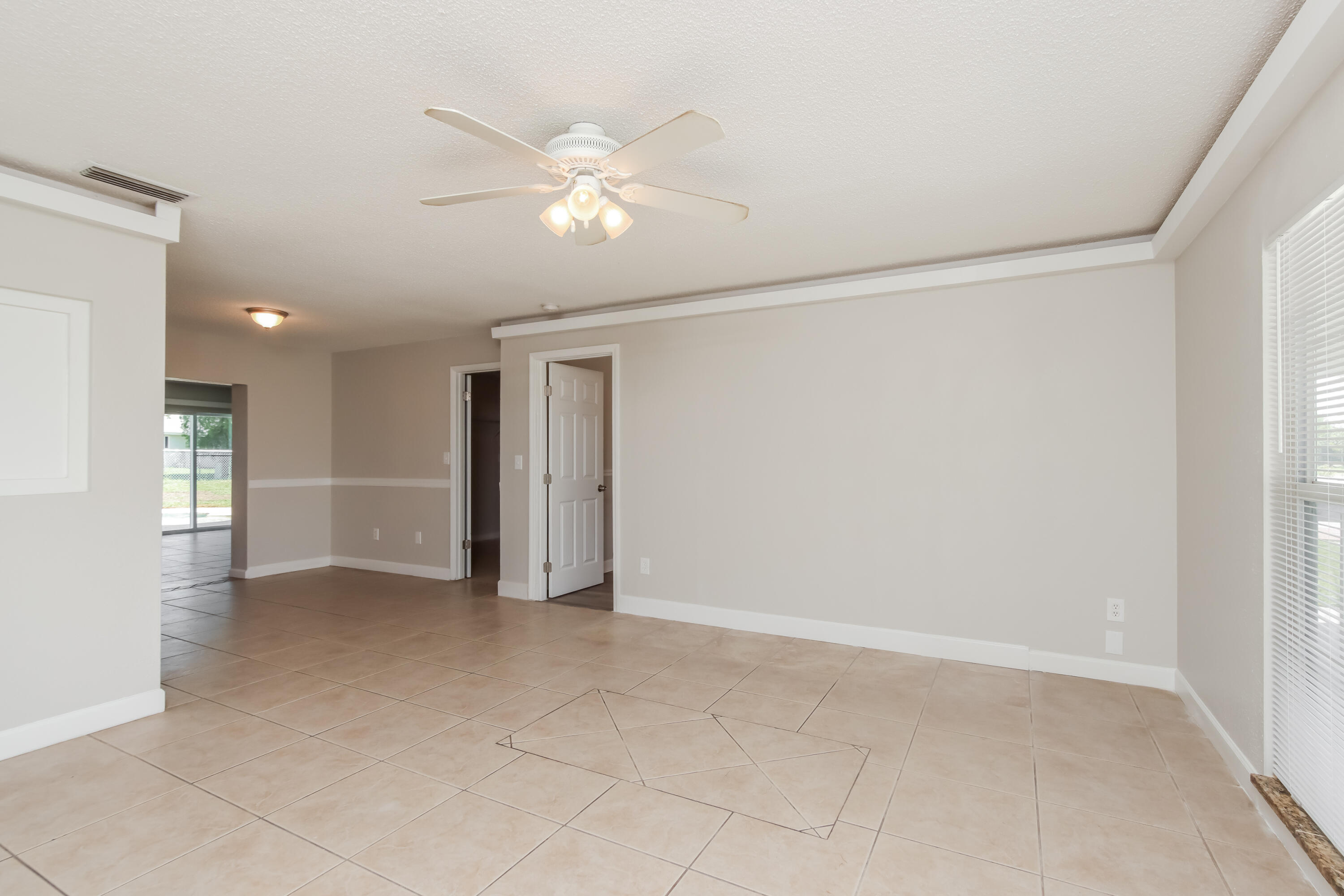1195 Cotton Road Northeast Palm Bay, FL 32905 - Photo 5 of 17 a view of an empty room with a window