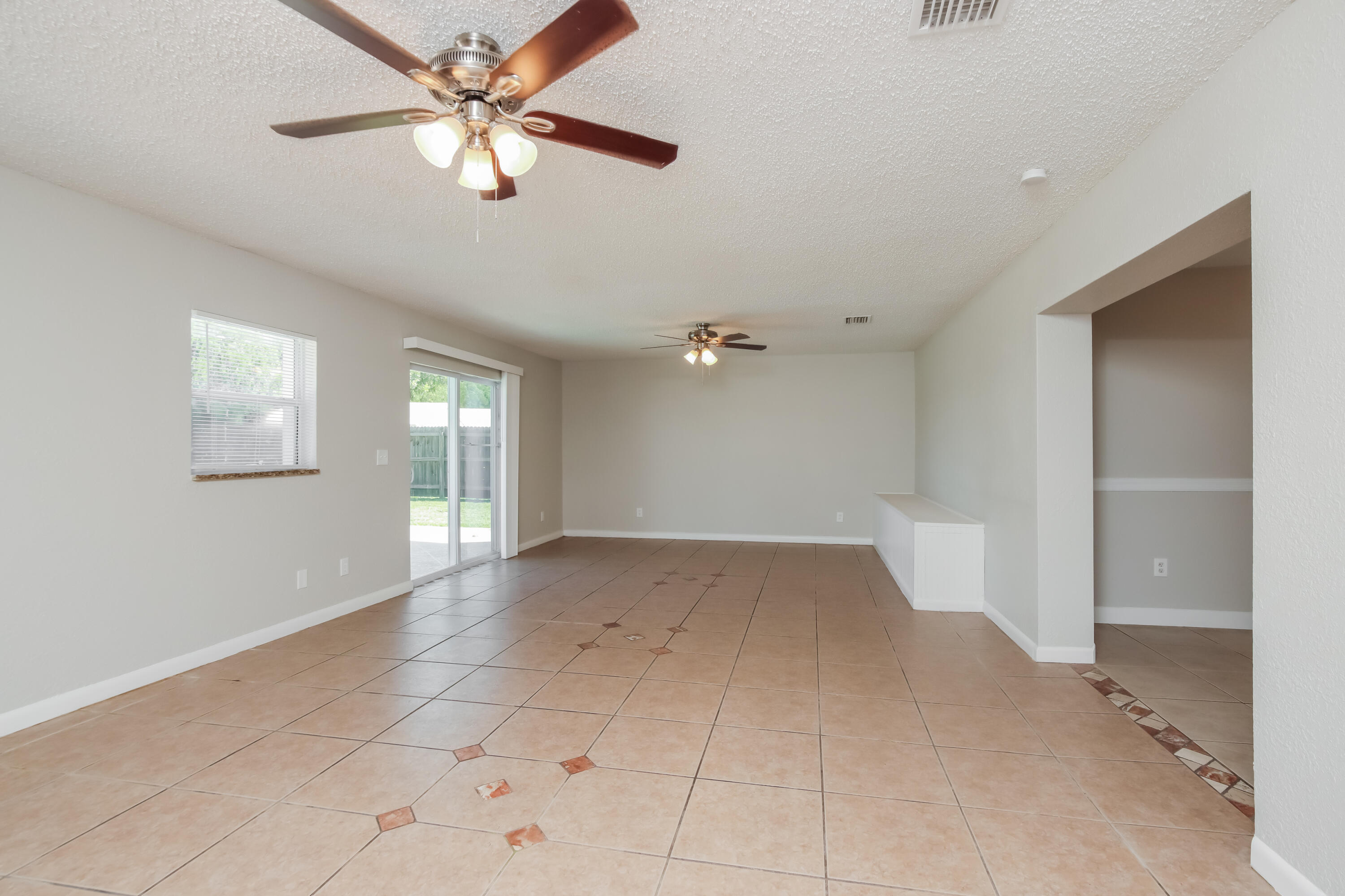 1195 Cotton Road Northeast Palm Bay, FL 32905 - Photo 8 of 17 wooden floor in an empty room with a window