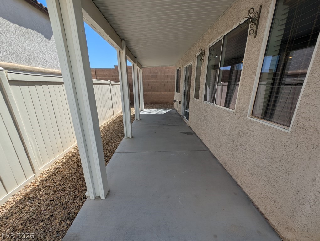 9121 Spoonbill Ridge Place Las Vegas, NV 89143 - Photo 23 of 26 A spacious covered patio provides a shaded retreat alongside the low-maintenance rock landscaping.